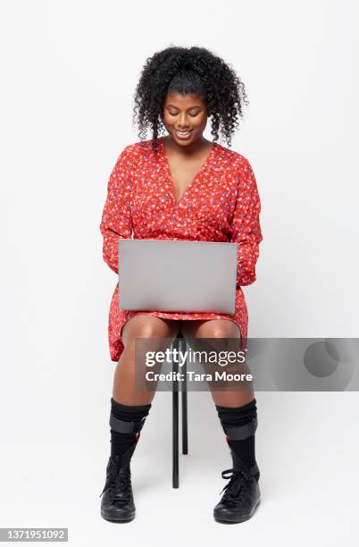 woman with laptop - woman stool stock pictures, royalty-free photos & images