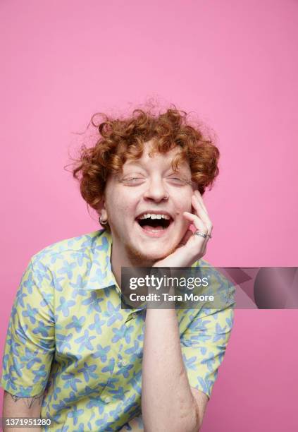 cheerful transsexual male against pink background - people studio shot stock pictures, royalty-free photos & images