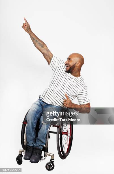 man in wheelchair pointing up - celebration people on white stock-fotos und bilder