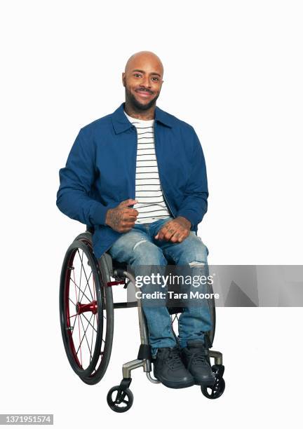 man sitting in wheelchair against white background - completamente calvo - fotografias e filmes do acervo