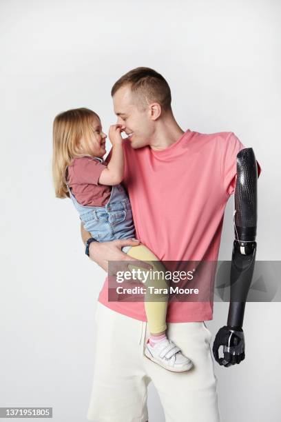 father with disability with young daughter - artificial limb stock pictures, royalty-free photos & images