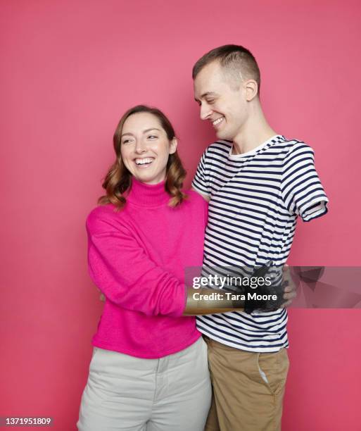 amputee couple embracing - cultural diversity stock-fotos und bilder