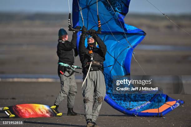 Kite surfers enjoy the winds off Barassie Beach on February 21, 2022 in Troon, United Kingdom. Storm Franklin, which has prompted flood warnings and...