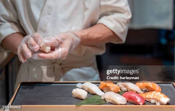 chef preparing sushi - sushi bar stock pictures, royalty-free photos & images