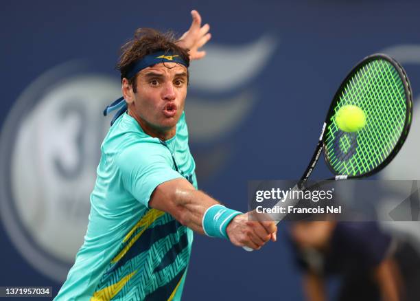 Malek Jaziri of Tunisia plays a backhand against Filip Krajinovic of Serbia during day eight of the Dubai Duty Free Tennis at Dubai Duty Free Tennis...