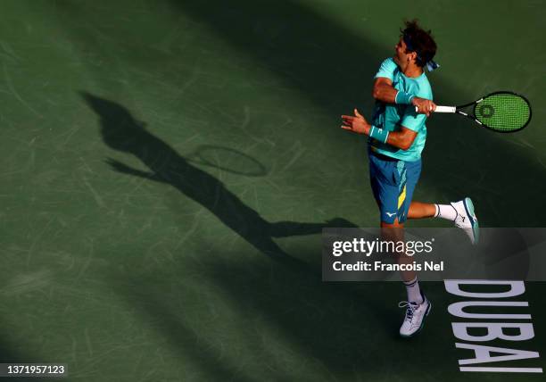 Malek Jaziri of Tunisia plays a shot against Filip Krajinovic of Serbia during day eight of the Dubai Duty Free Tennis at Dubai Duty Free Tennis...