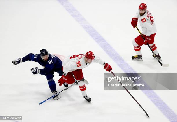 Liro Pakarinen of Finland, Anton Slepyshev, Nikita Nesterov of Russia during the Gold Medal game between Team Finland and Team ROC on Day 16 of the...