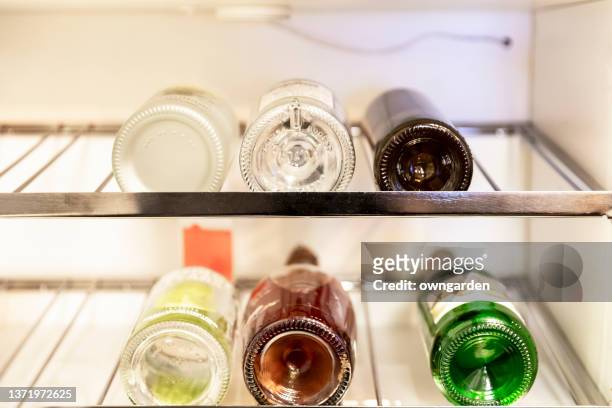 close-up of wine bottles in cabinet - mini bar imagens e fotografias de stock