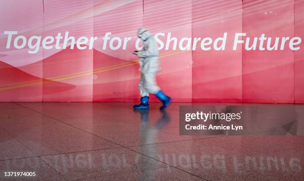 An airport staff member in a hazmat suit works at the Beijing Capital International Airport on February 21, 2022 in Beijing, China. Officials,...