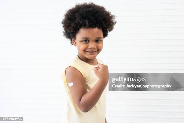 boy proud to have received vaccine in arm - delta i stock pictures, royalty-free photos & images