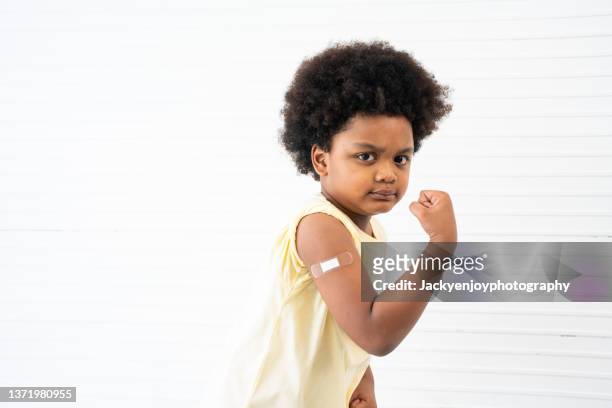 boy proud to have received vaccine in arm - kid studio shot stock pictures, royalty-free photos & images