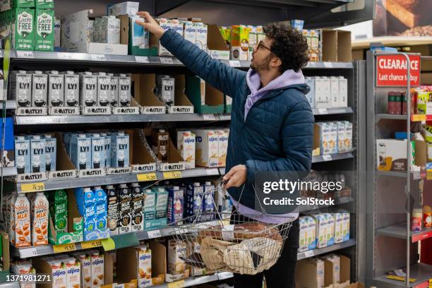 buying vegan alternative milk - usefull stock pictures, royalty-free photos & images