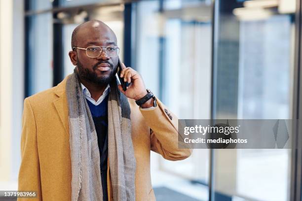 businessman having a conversation on the phone - mediaphotos stock pictures, royalty-free photos & images