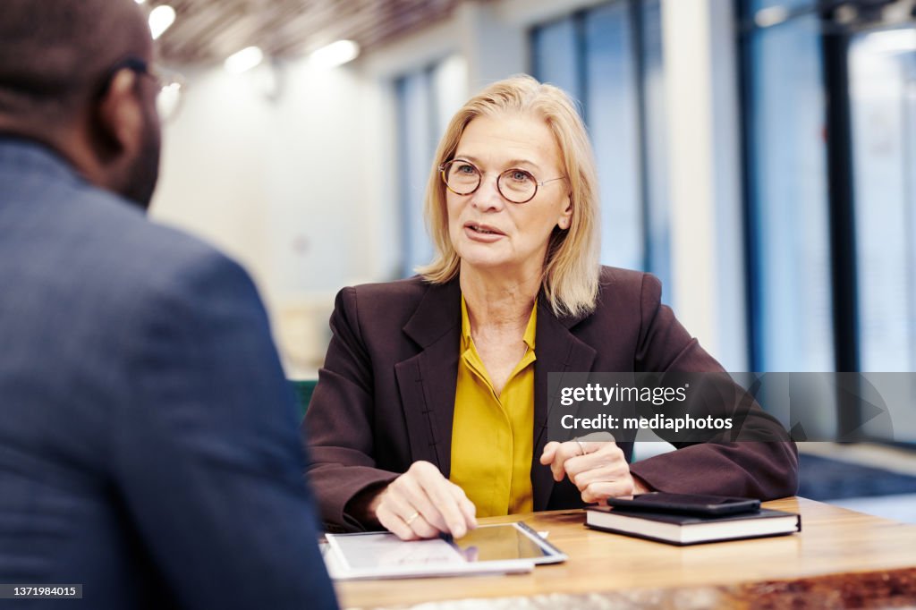 Lawyer discussing deal with her client
