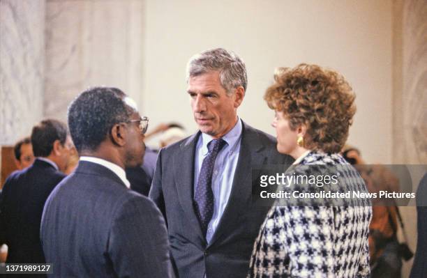 Married couple American Judge Clarence Thomas and attorney & activist Virginia Thomas speak with US Senator John Danforth during a break in testimony...