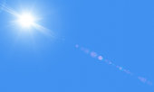 Sun in the blue sky with lensflare