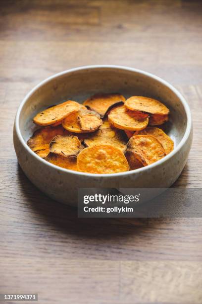 healthy vegan snacks, bowl of homemade  sweet potato crisps - baked sweet potato stock pictures, royalty-free photos & images