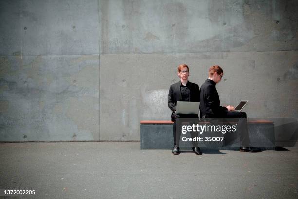 red hair twins working wireless - identical twin stock pictures, royalty-free photos & images