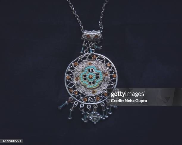 pendant on black fabric. - silver pendant stock pictures, royalty-free photos & images