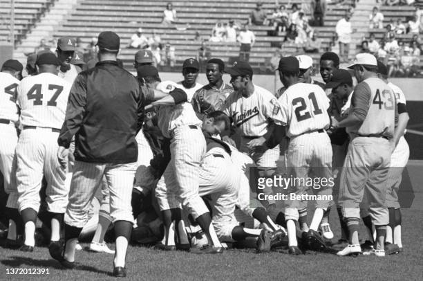 Sal Bando grabs ahold of Twins' Craig Nettles after Athletics Reggie Jackson charged the mound knocking down Twins pitcher Dick Woodson during the...