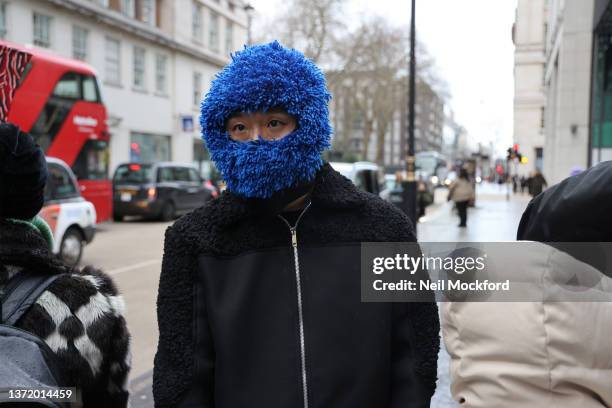 Guest wearing a blue mitt balaclava attends Supriya Lele at The Old Selfridges Hotel during London Fashion Week February 2022 on February 21, 2022 in...