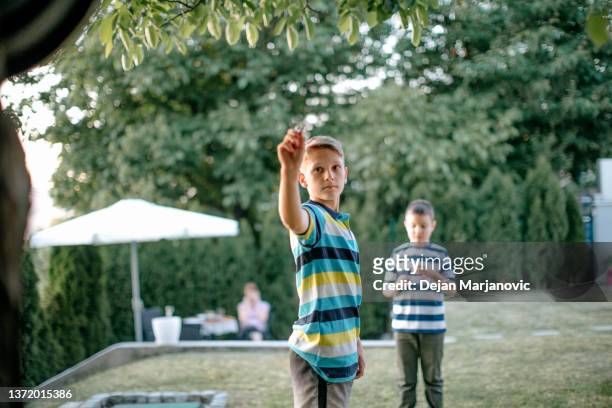 kids playing darts in the back yard - throwing darts stock pictures, royalty-free photos & images