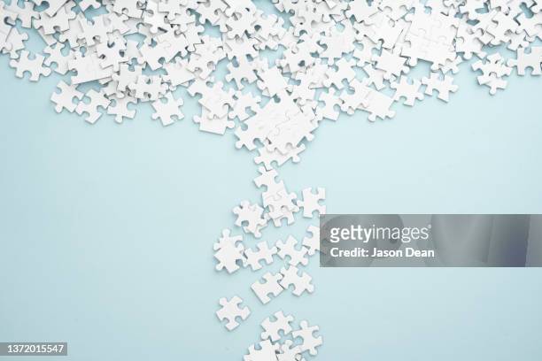 white puzzle pieces - puzzleteile stock-fotos und bilder