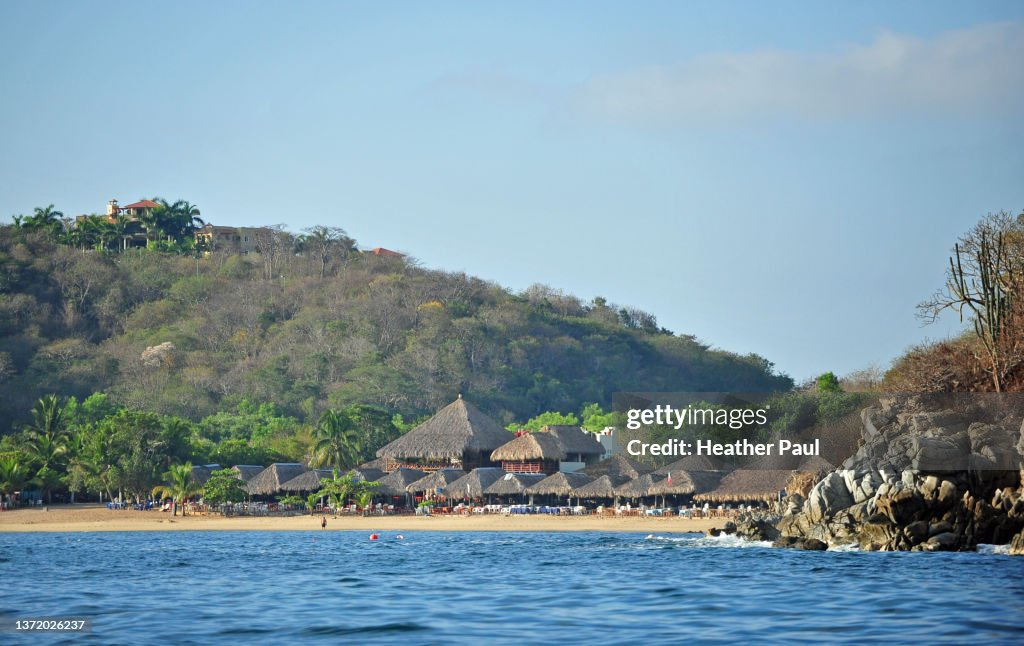 Beach and restaurants at Bahia Maguey in Huatulco, Mexico