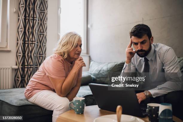 mother is tired of her son's business not taking off - baby boomer millennial stock pictures, royalty-free photos & images