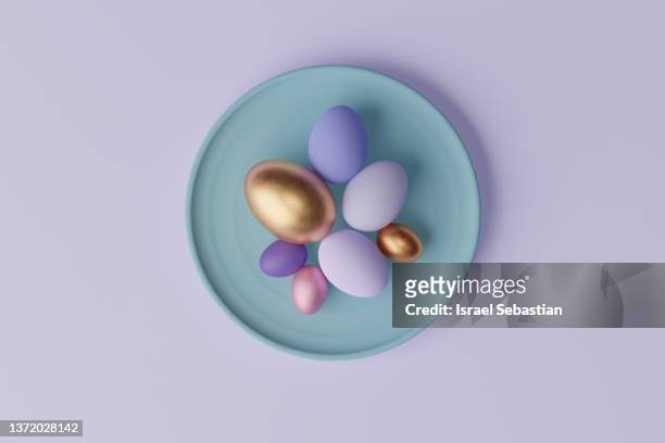 view from above of a 3d illustration colorful easter eggs on purple background - easter eggs stock-fotos und bilder