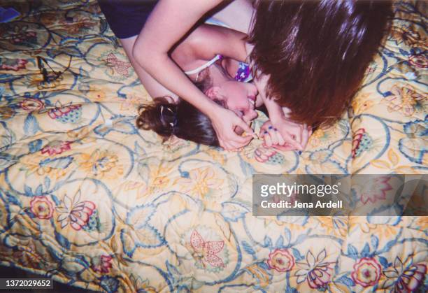 siblings fighting, teasing, sisters wrestling, vintage family photo - bed conflict stock pictures, royalty-free photos & images