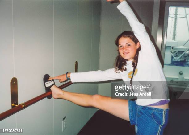 vintage teenager having fun stretching 1990s y2k fashion 2000s style - leg stretch girl stock pictures, royalty-free photos & images
