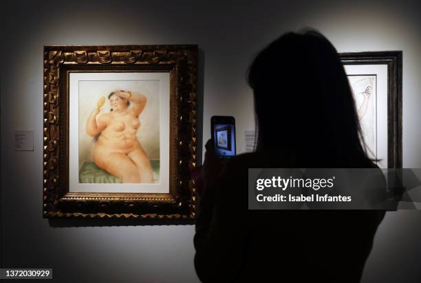 Visitor looks at "Mujer con espejo" by artist Fernando Botero during the opening day of the Salon de Arte Moderno at the Carlos de Amberes Foundation...