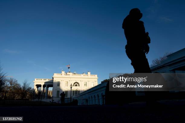 Secret Service agent walks past the White House on Presidents' Day, on February 21, 2022 in Washington, DC. U.S. President Joe Biden is spending the...