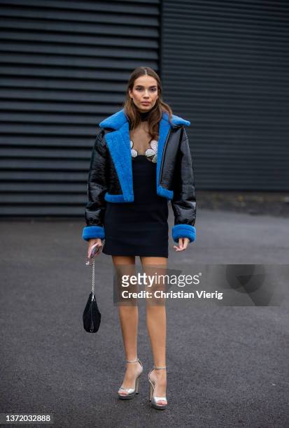 Hana Cross is seen wearing black blue shearling jacket, black dress, Prada bag, silver heels outside David Koma during London Fashion Week February...
