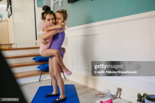 the sisters practice ballet at home - school gymnastics stock pictures, royalty-free photos & images