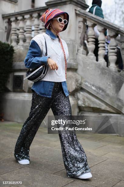 Guest is seen wearing a Denim shirt with a White Knitted Sleeveless Top at Roksanda during London Fashion Week February 2022 on February 21, 2022 in...