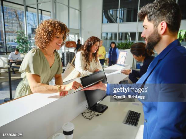 hotel lobby with employees and guests - hotel lobby imagens e fotografias de stock