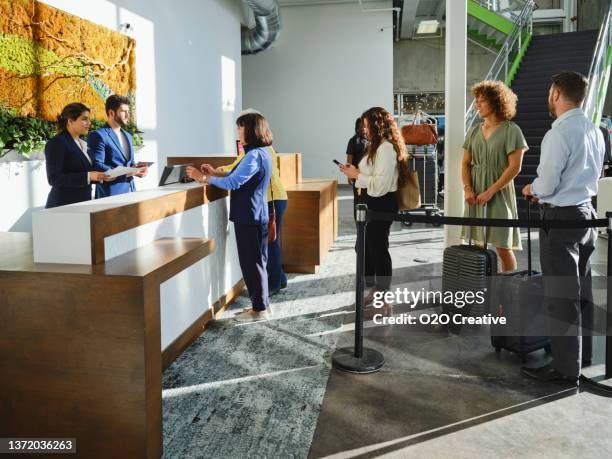 hotel lobby with employees and guests - lining up stock pictures, royalty-free photos & images