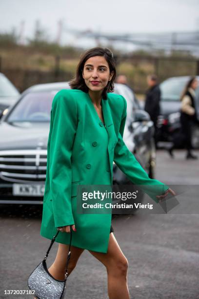 Bettina Looney seen wearing silver Prada bag, green oversized blazer, black dress outside David Koma during London Fashion Week February 2022 on...