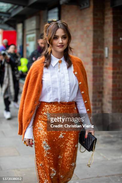 Actress Jenna Coleman is seen wearing orange skirt, cardigan, white blouse, black bag outside Erdem during London Fashion Week February 2022 on...