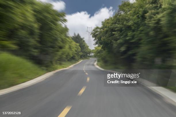 speed sense of motion blur processing suburban highway - car racing blurred motion bildbanksfoton och bilder