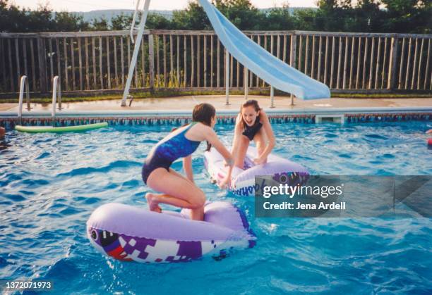 competition: vintage 1990s summer fun sisters friends playing in swimming pool - 1990 1999 photos stock pictures, royalty-free photos & images