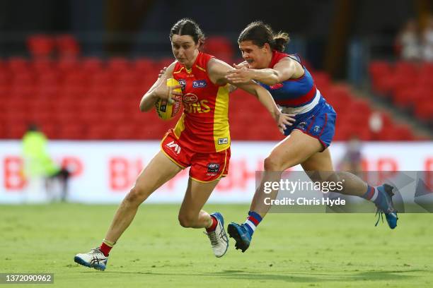 Elizabeth Keaney of the Suns is tackled during the round three AFLW match between the Gold Coast Suns and the Western Bulldogs at Metricon Stadium on...