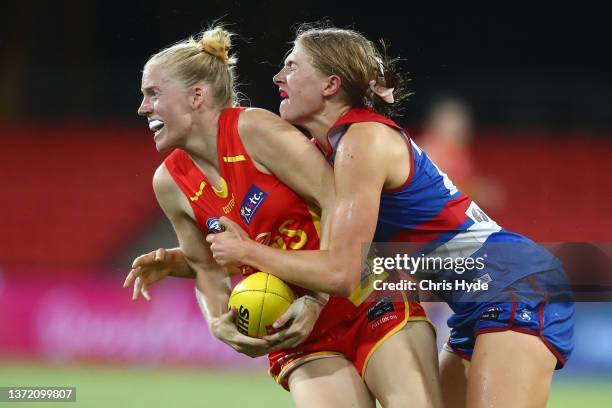 Shannon Danckert of the Suns is tackled during the round three AFLW match between the Gold Coast Suns and the Western Bulldogs at Metricon Stadium on...