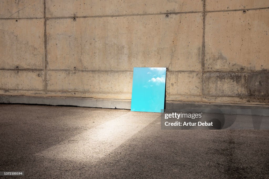 Conceptual picture of a mirror reflecting sky in minimal architecture.