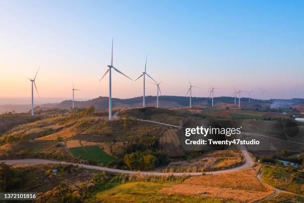 aerial view of wind turbine farm on the hill produces electricity for clean energy - hill station stock pictures, royalty-free photos & images