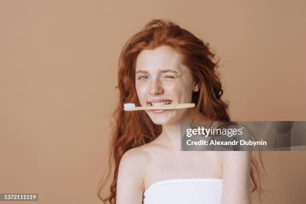 beautiful caucasian woman with tooth eco brush on beige background with copy space. - man washing his teeth stock-fotos und bilder