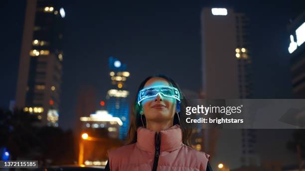 young woman wearing augmented reality glasses - smart glasses eyewear stock pictures, royalty-free photos & images