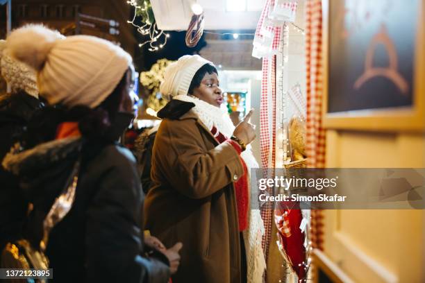 mother and daughter window shopping during christmas - zagreb night stock pictures, royalty-free photos & images